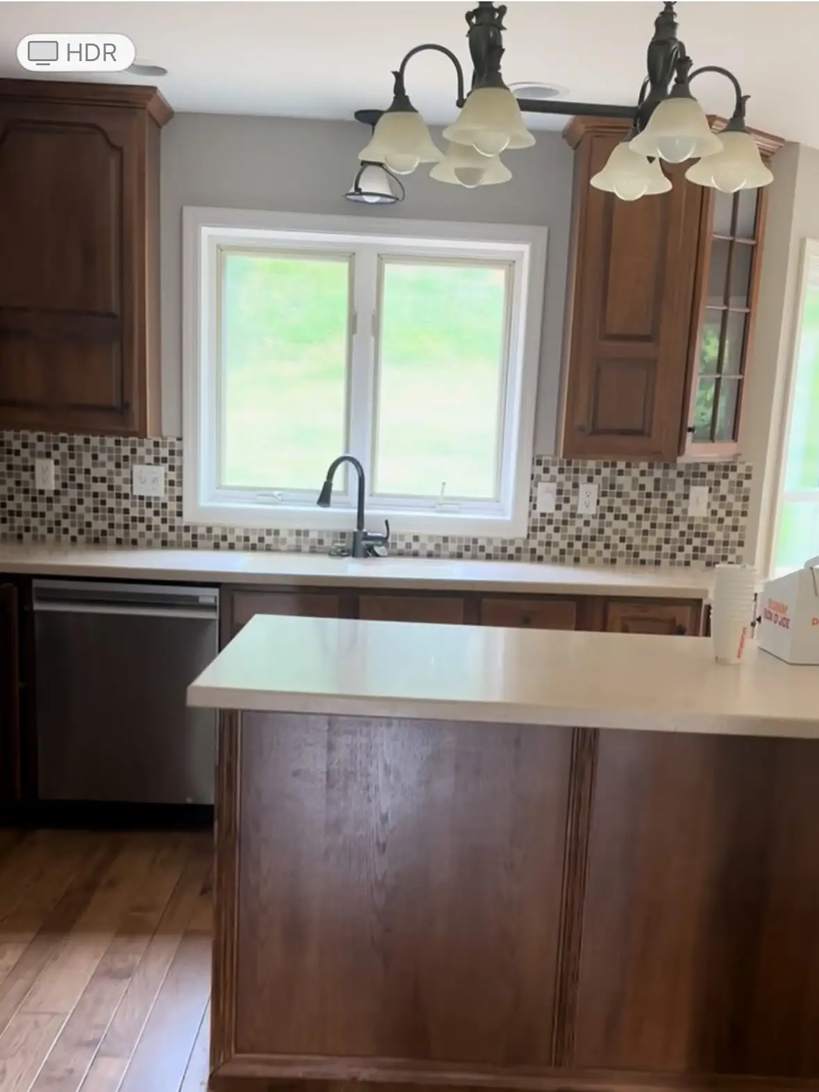 Kitchen before — wood cabinets and dated finishes
