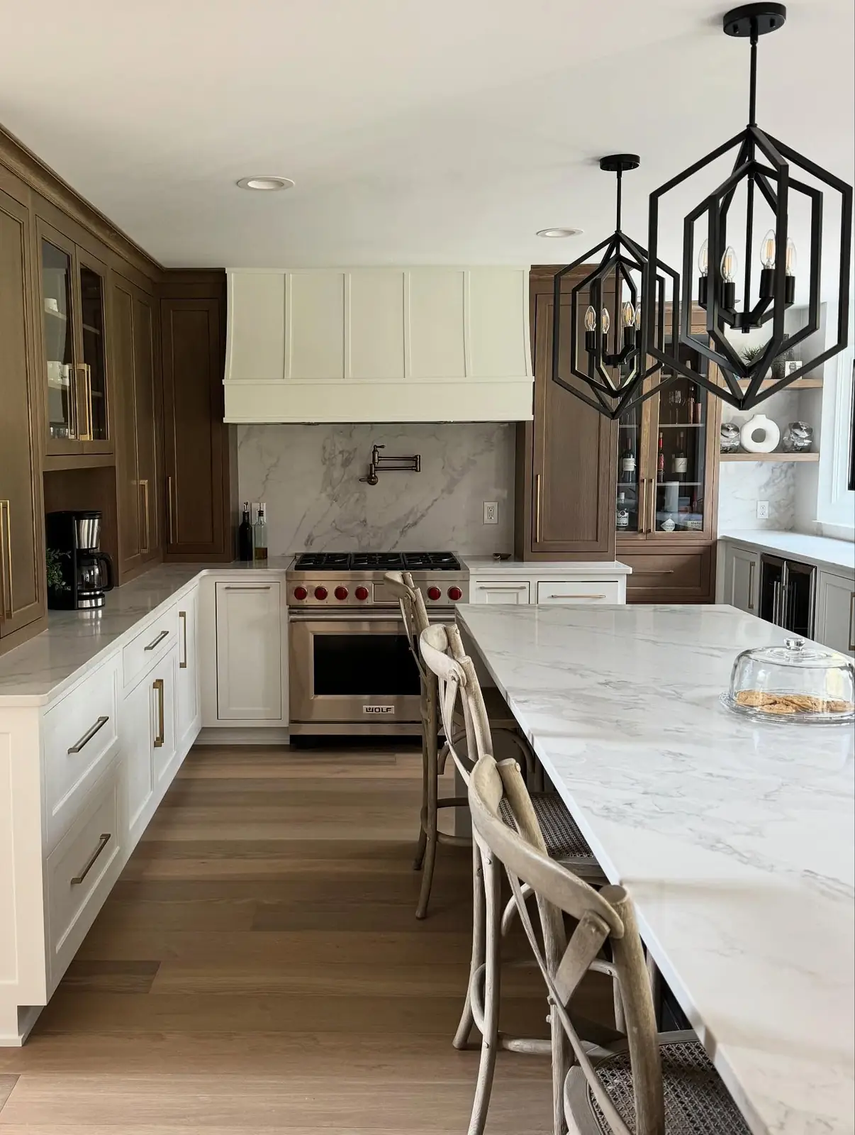 Kitchen with marble counters and lantern pendants
