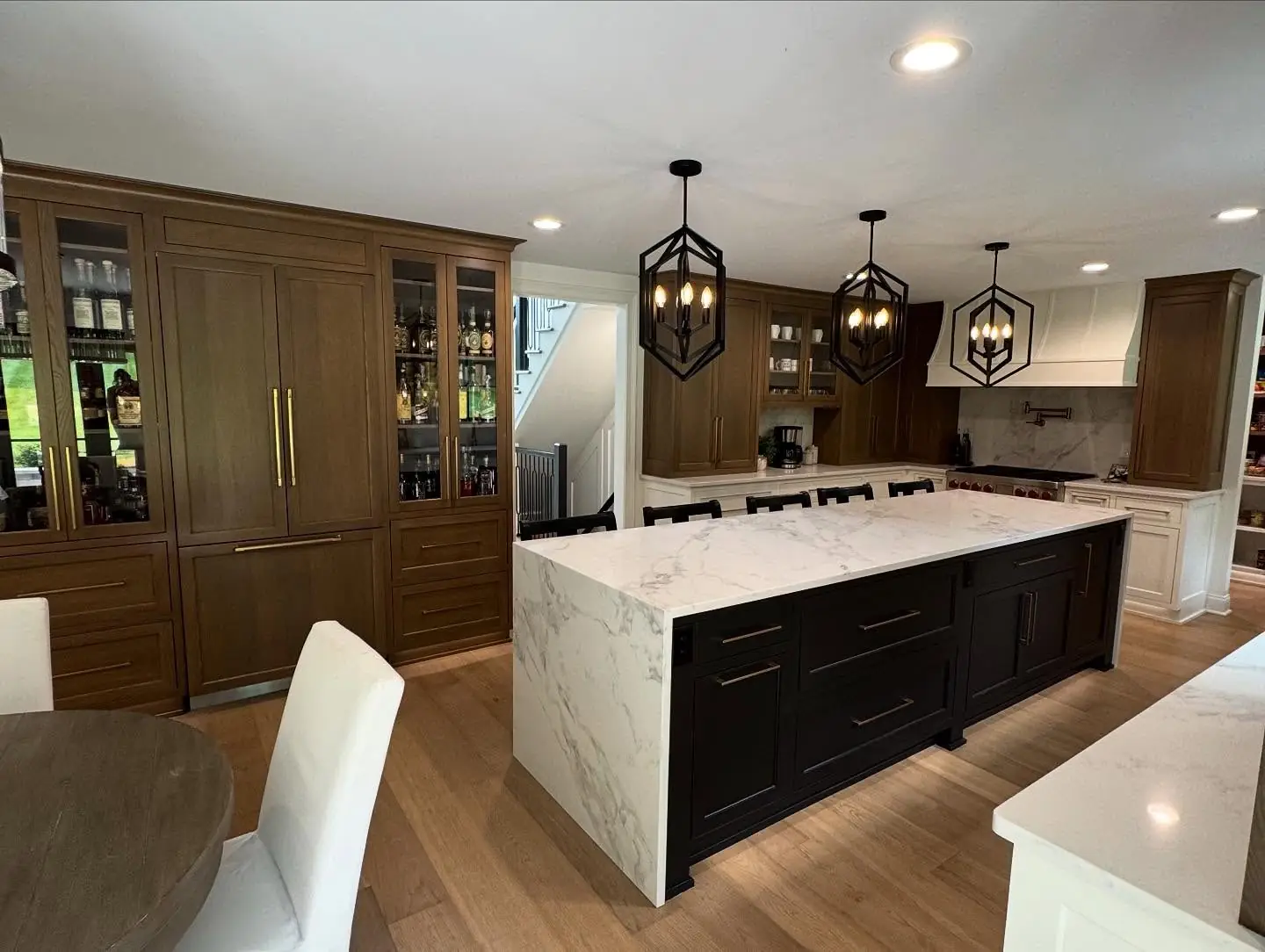 Kitchen island after — white island and dark millwork
