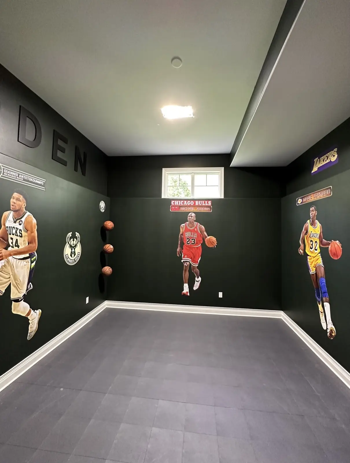 Sports den after — dark walls, basketball decals and a sport tile floor