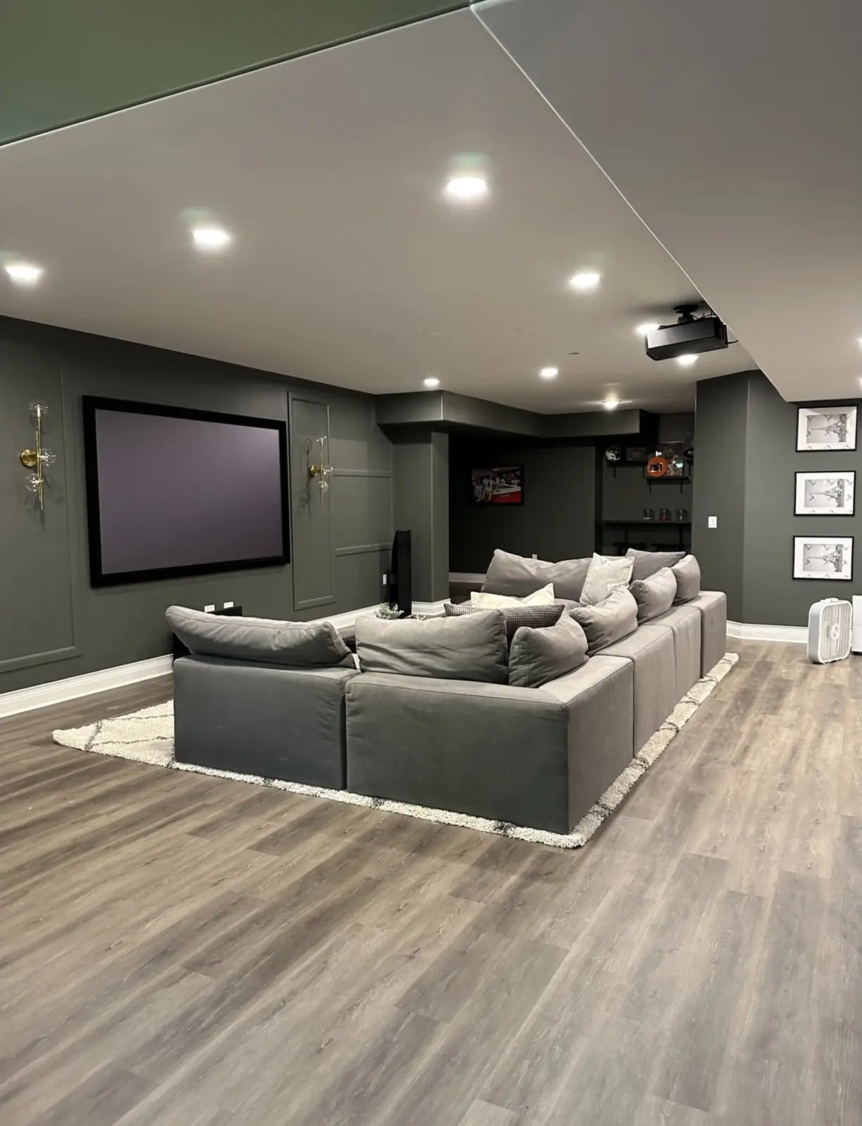 Theater with a sectional and a projection screen — Brookstone