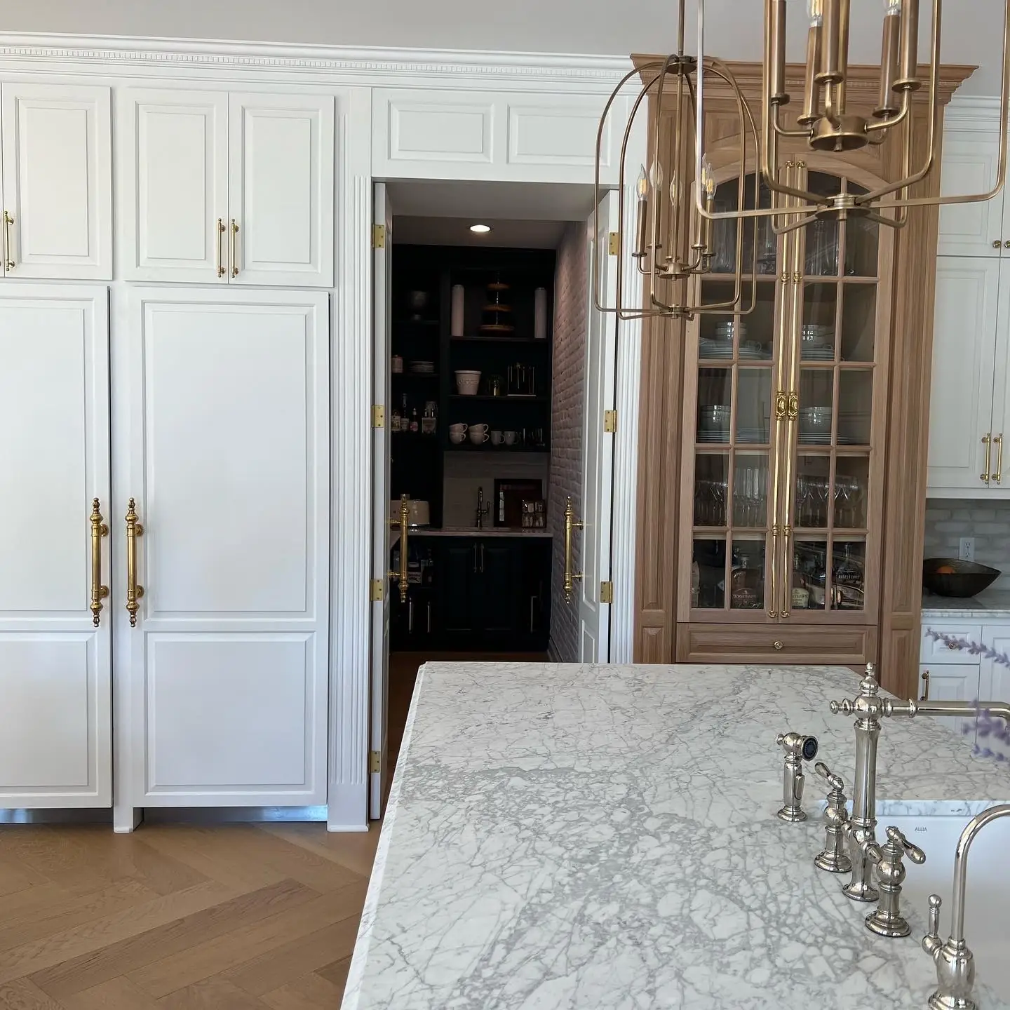 Paneled pantry door off the kitchen — French-Inspired Residence