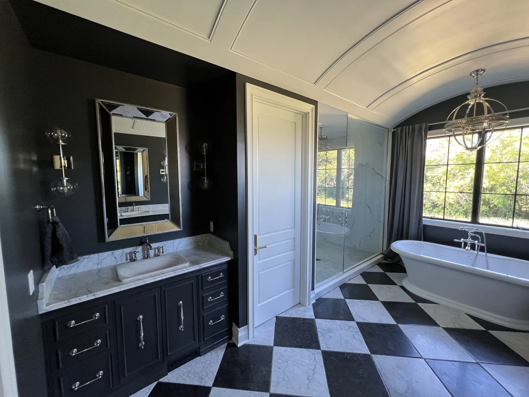 Primary bath with a barrel-vaulted ceiling and a freestanding tub
