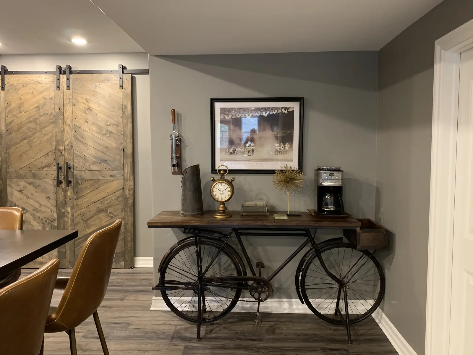 A bicycle console table beside rustic barn doors