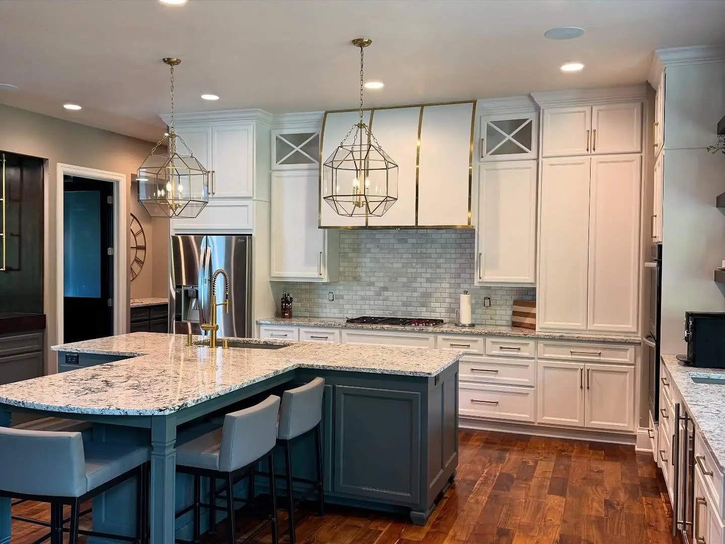 The Legend View kitchen: a dark island with seating beneath lantern pendants