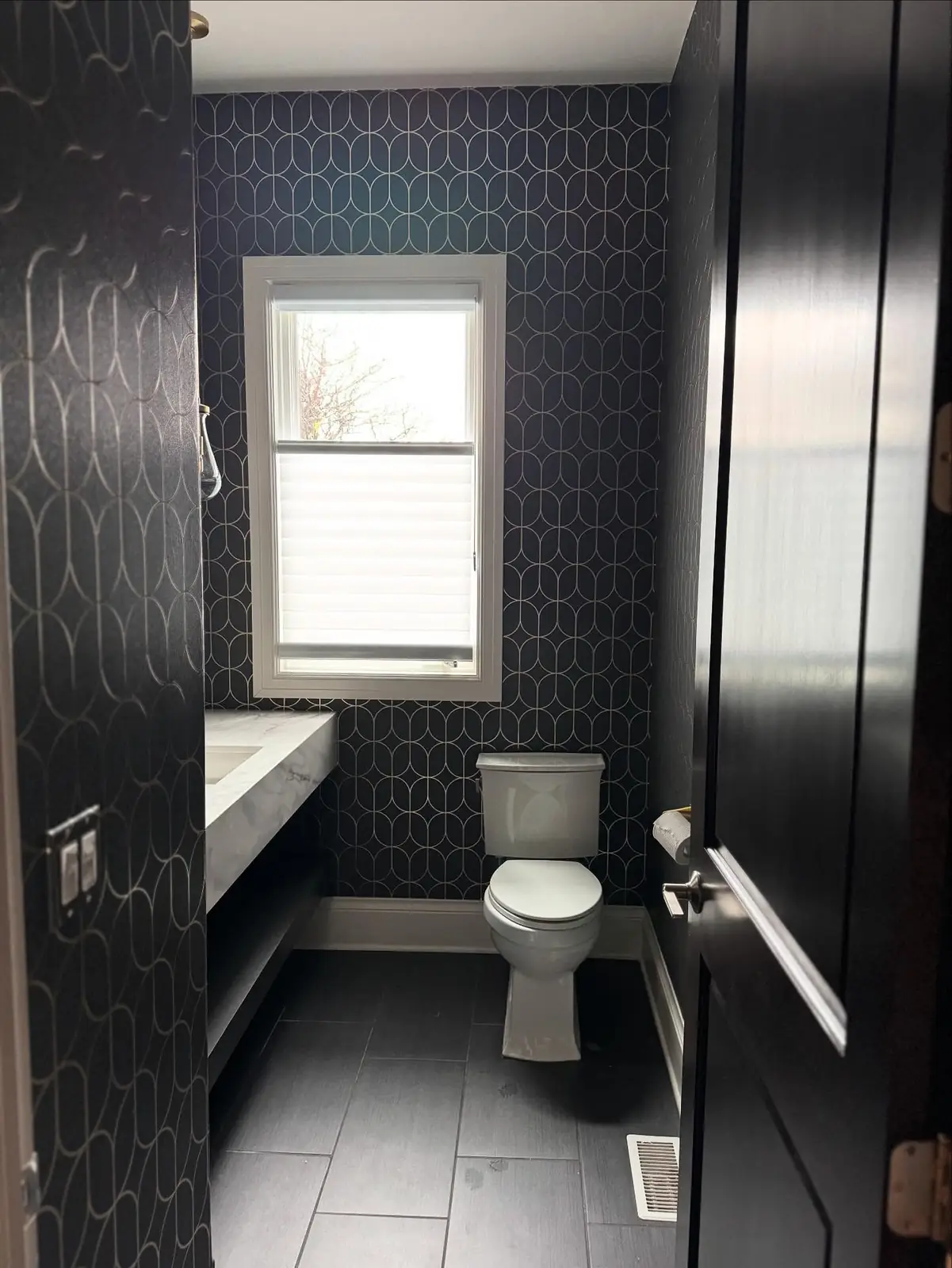 Powder room with black wallpaper