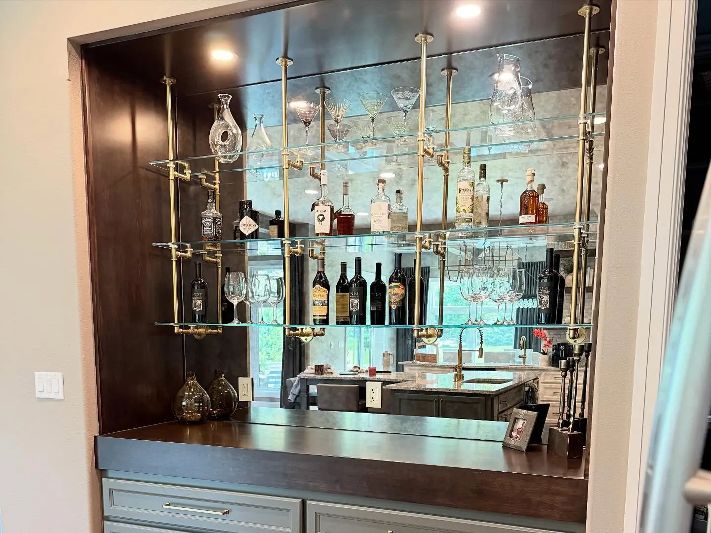 Bar with glass shelving and brass accents