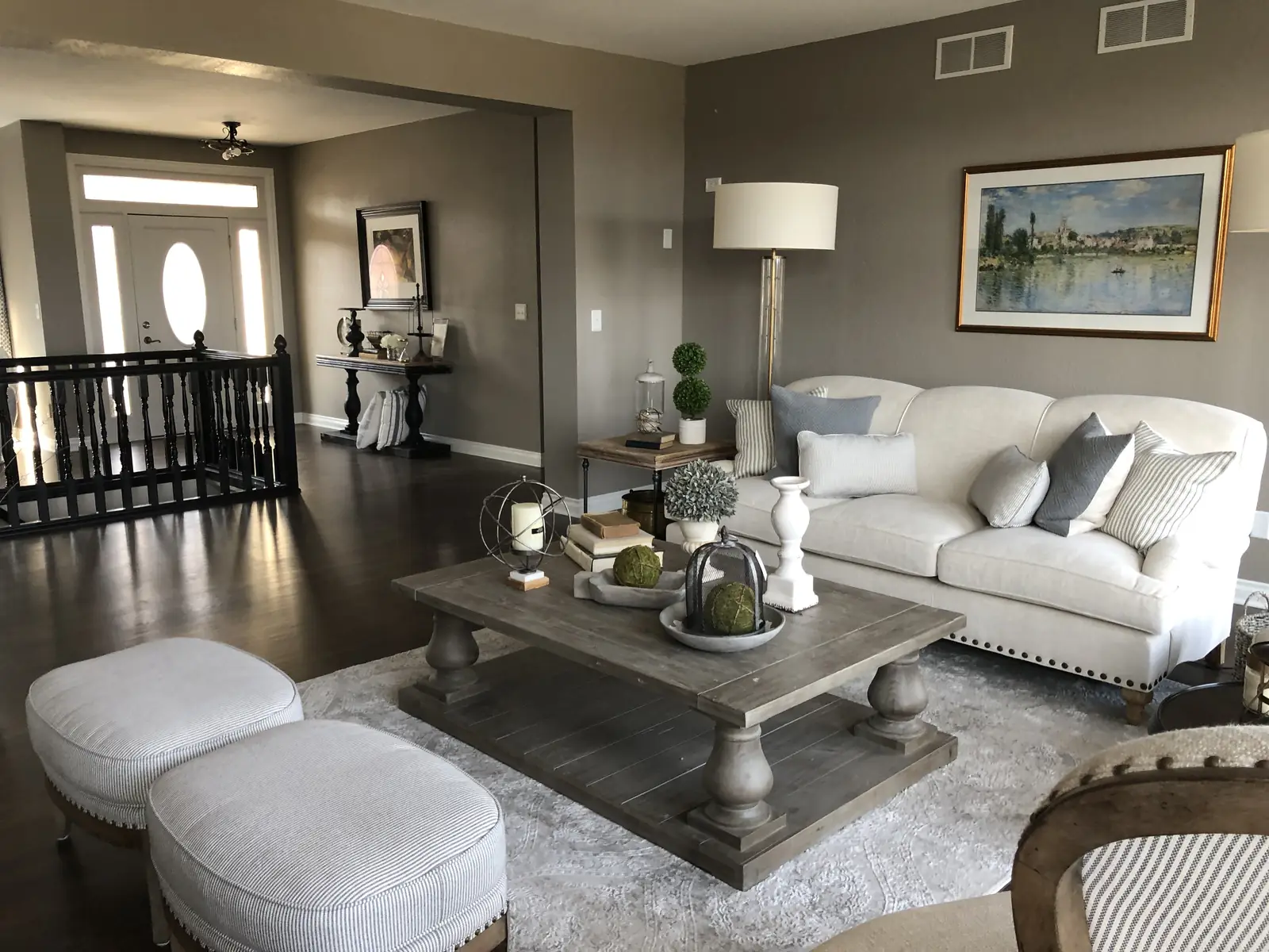 Living room with a tufted sofa and paired ottomans — Ridgefield Remodel