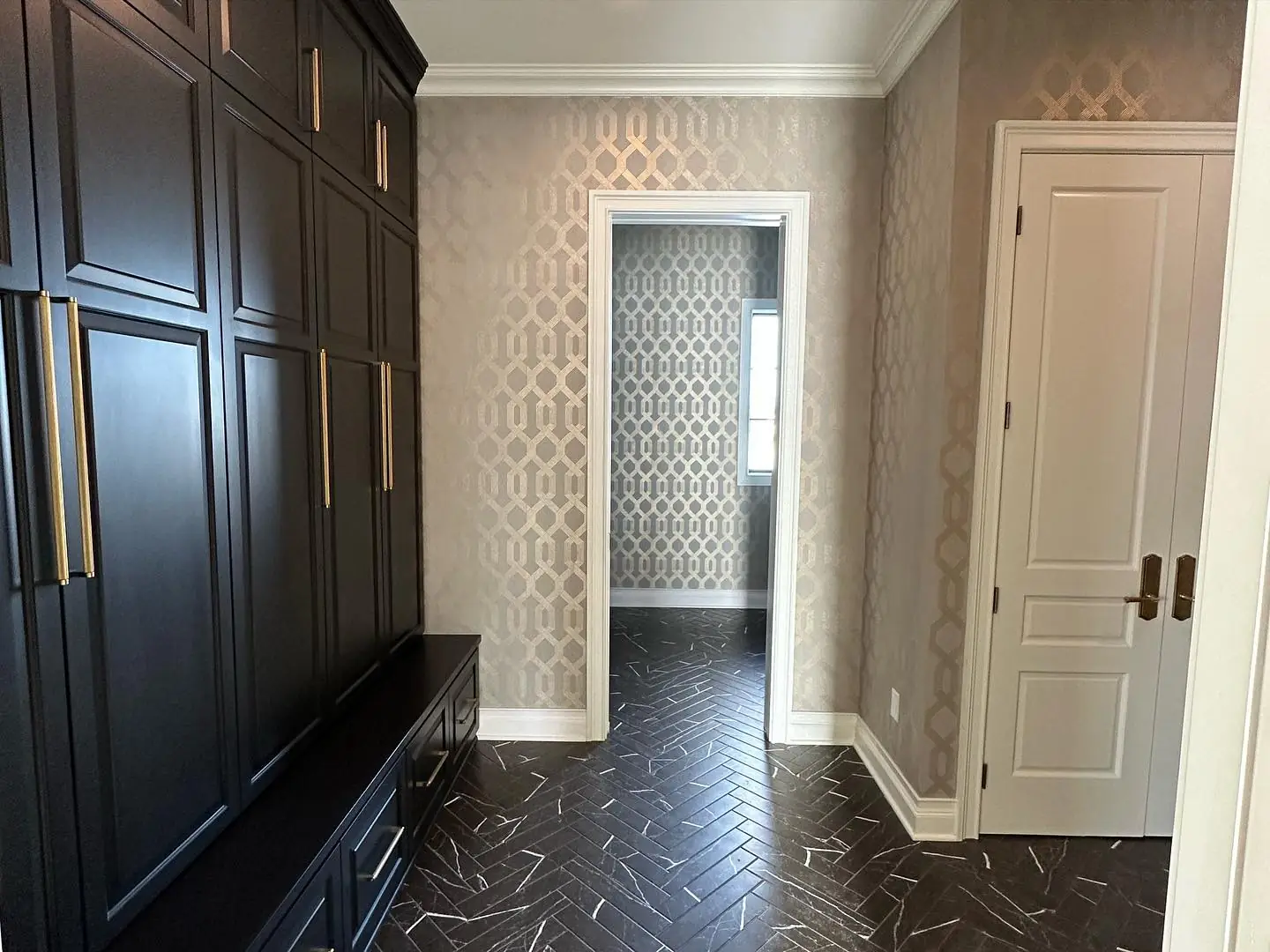 Mudroom wall of built-in lockers — French-Inspired Residence