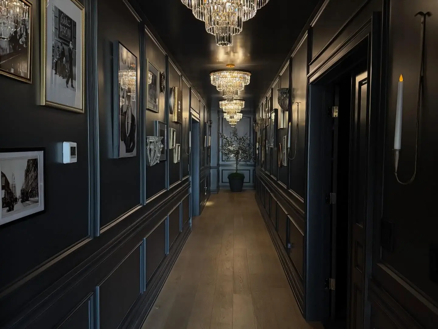 Hallway lined with paneling and art