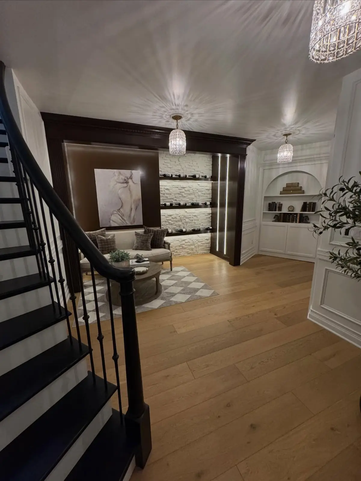 Stair down to the lower level, past the paneled foyer