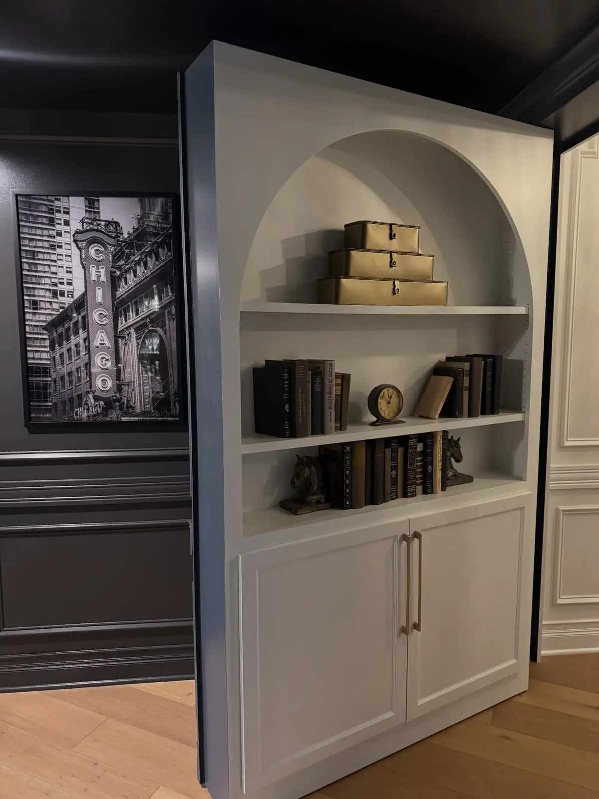 Arched bookcase door swung open to the speakeasy